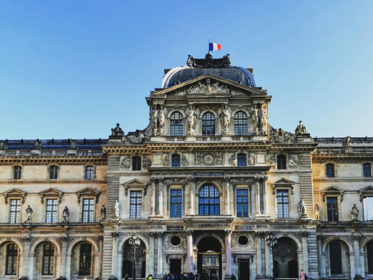 a large building with statues in front of it