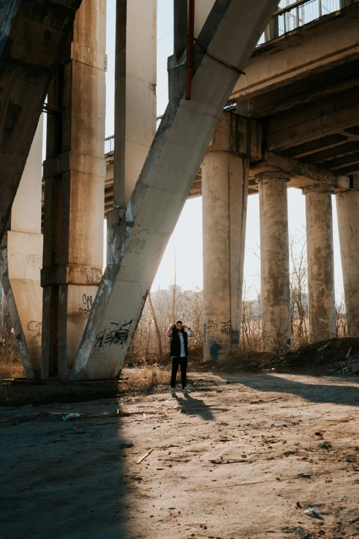 the man is walking down the dirty road