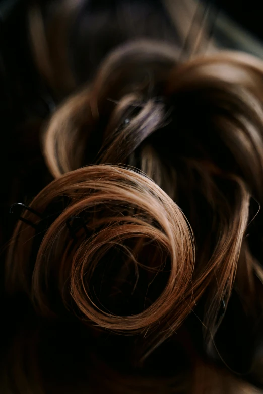 a hair bundle in a pile in a black room