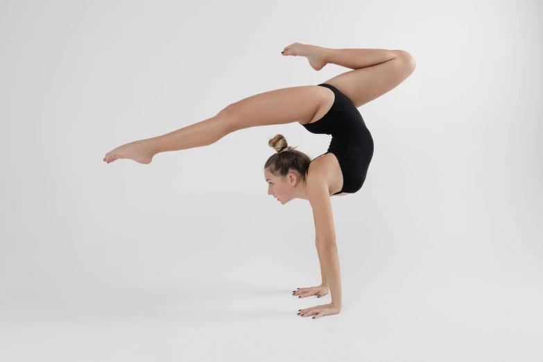 a woman is doing a handstand in a tight - fitting outfit