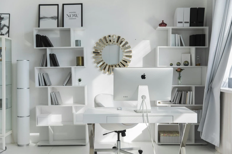 an office space with a white desk and chairs