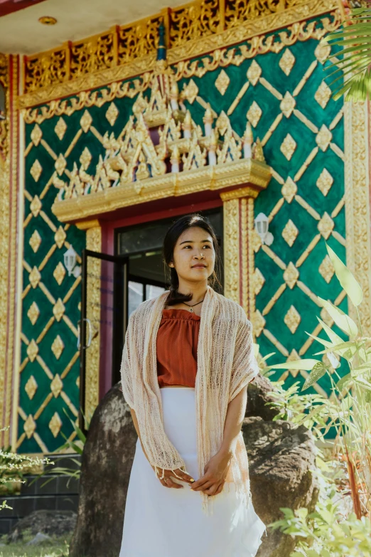 woman standing in front of an art deco building