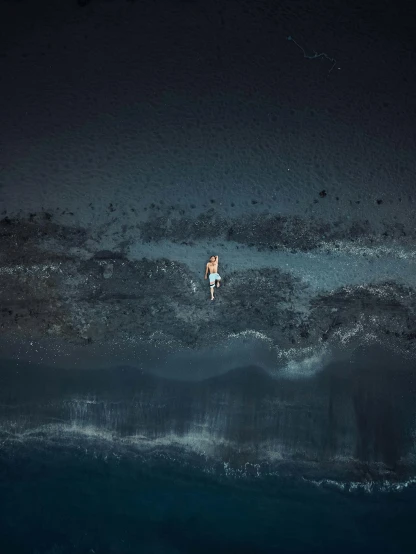 two people floating in the ocean at night
