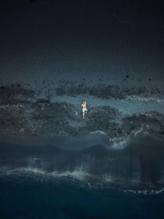 two people floating in the ocean at night
