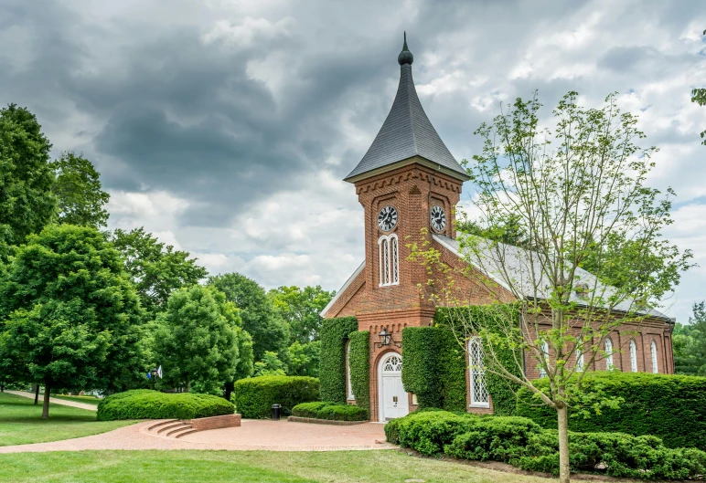 a beautiful church with steeple on a cloudy day