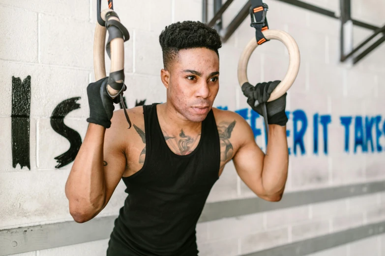 a man holding several hoop rings on one arm