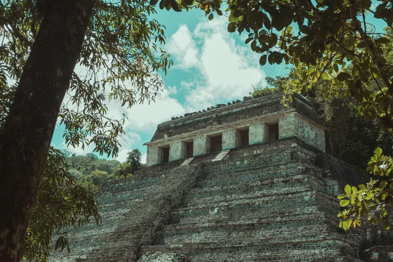 a large building with a steep pyramid and several windows at the top