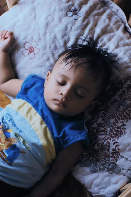 a small child sleeping in the middle of a bed