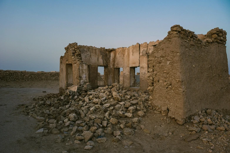 the remains of a destroyed building sitting on a plain