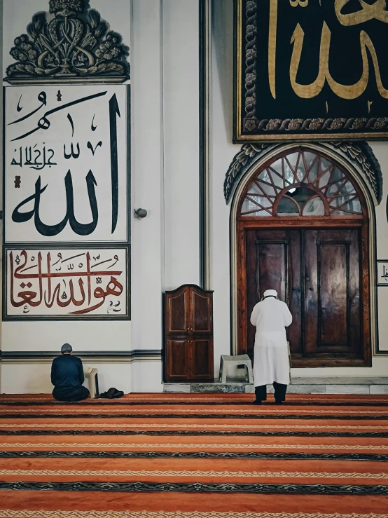 two men standing in front of an islamic church