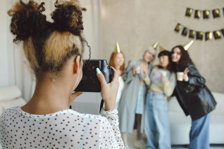 women standing around with gold party hats on