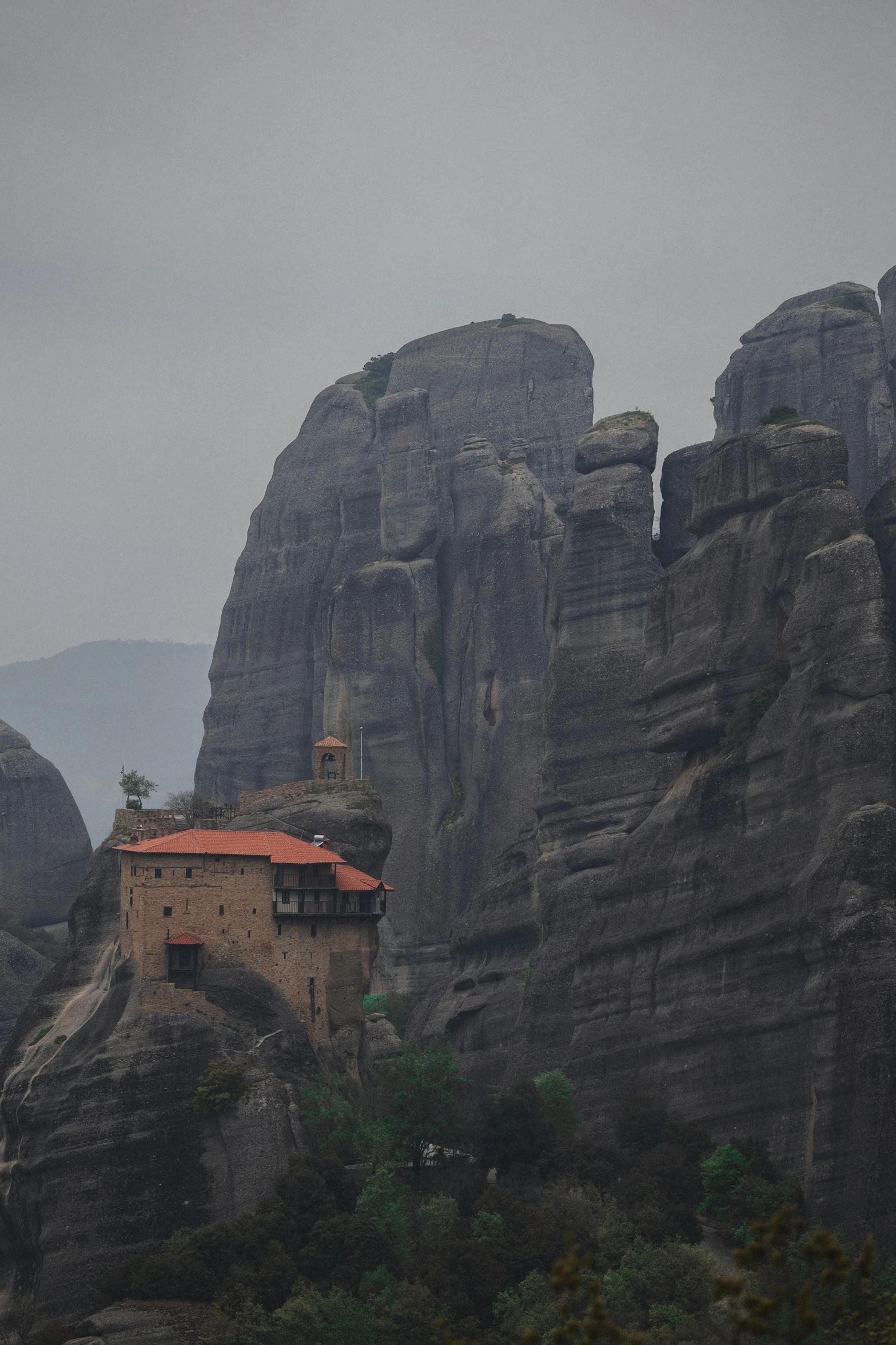 a church sitting in the middle of a rocky mountain range