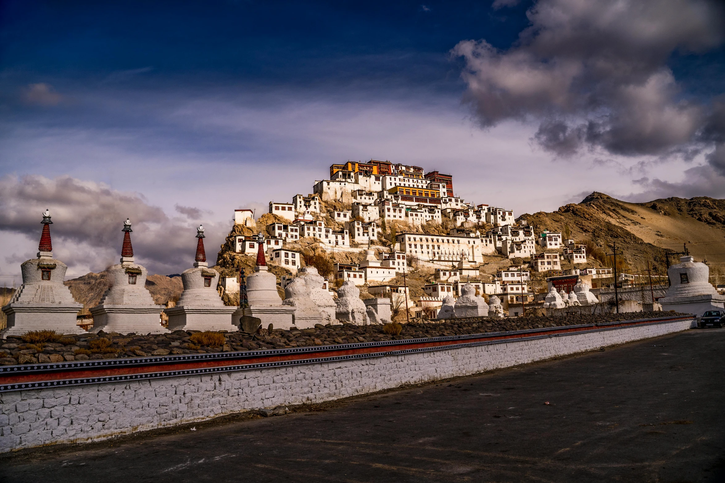 some very pretty buildings by a mountain and a road