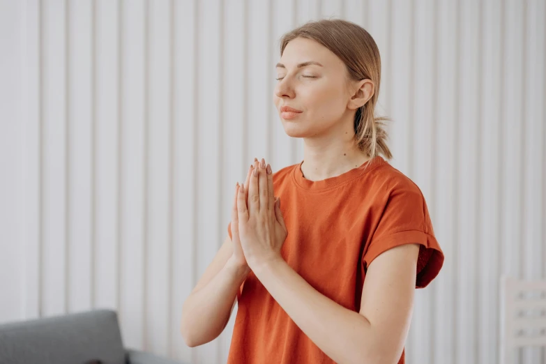 a young lady praying and looking up