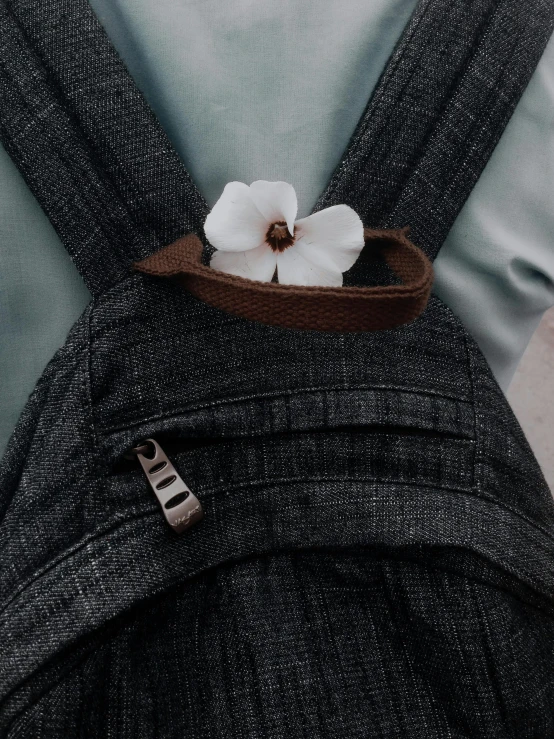 a white flower in a wooden bow tie