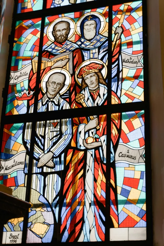 a stained glass window with several figures