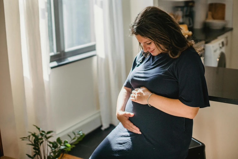 a pregnant woman is posing for a po