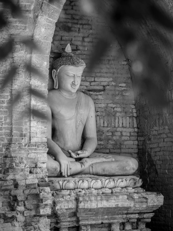 a statue sitting in the middle of brick steps