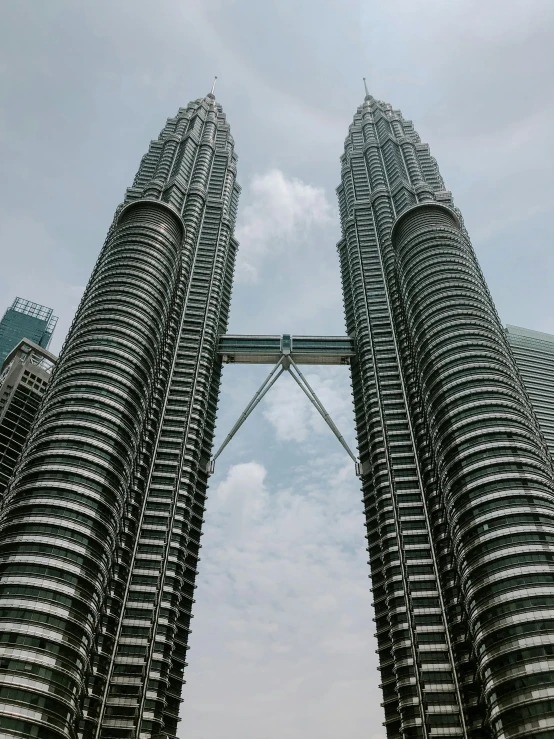 a tall tower structure with two spires standing next to each other