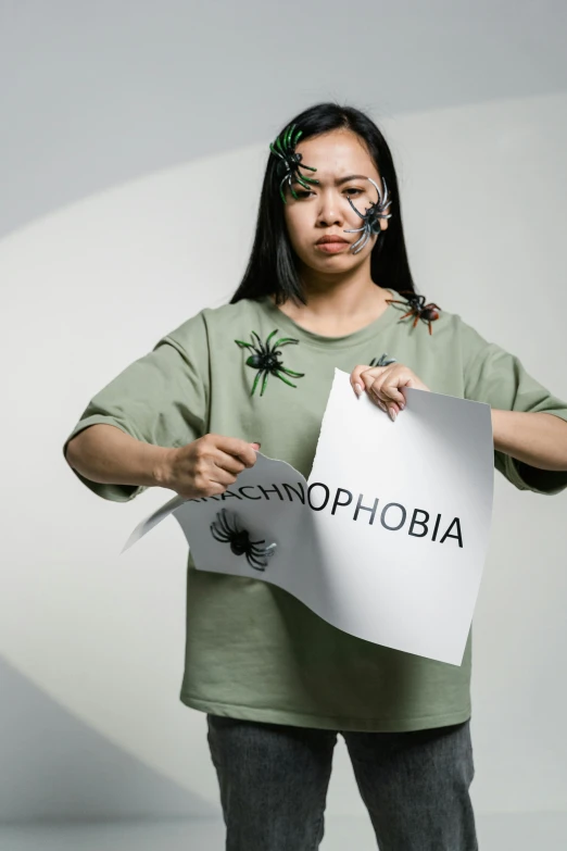 a woman holding a sign that says the name of an upcoming movie