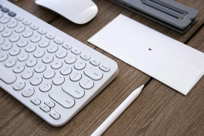 keyboard and mouse on a wooden table top