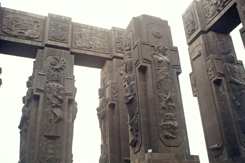 the pillars have carvings on them with figures