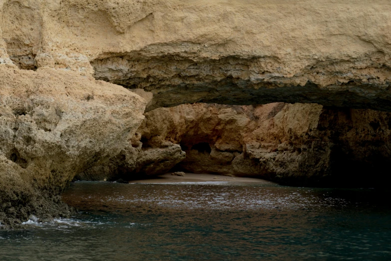 a cave in the desert is partially covered by water