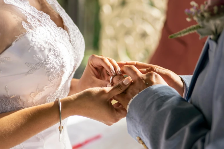 a bride and groom hold hands at the altar