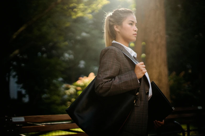 a woman sitting on a bench holding a bag