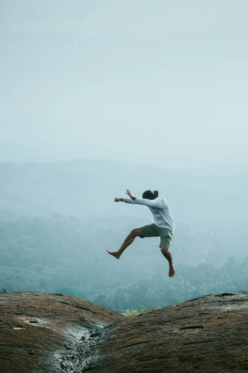 a man who is jumping into the air with his hands on the ground