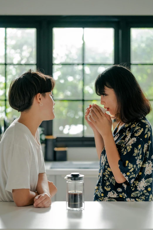 two people sit at a table having breakfast