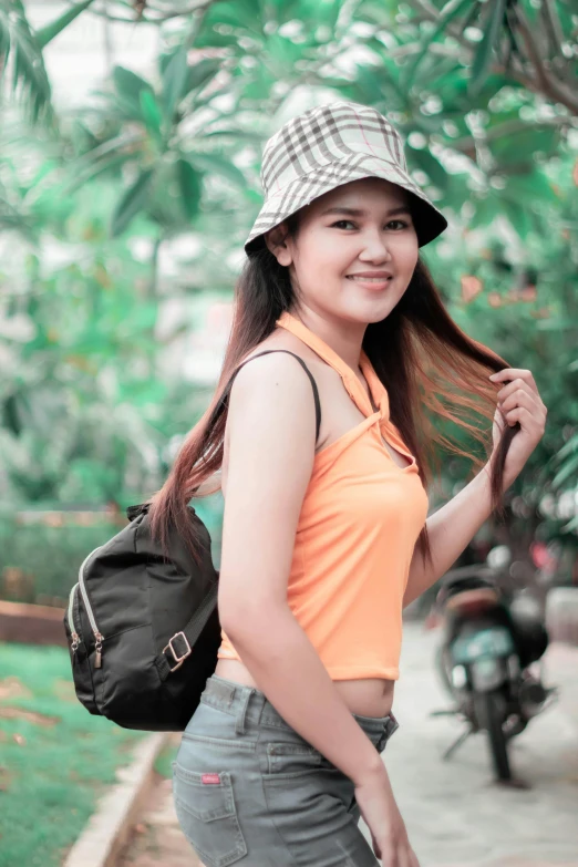 a young lady posing for the camera with her hair blowing in the wind