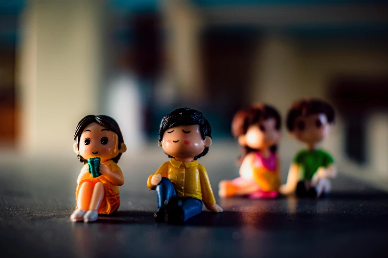 group of small figurines with sitting on wooden table