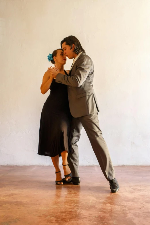 a man and woman are standing in a ballroom