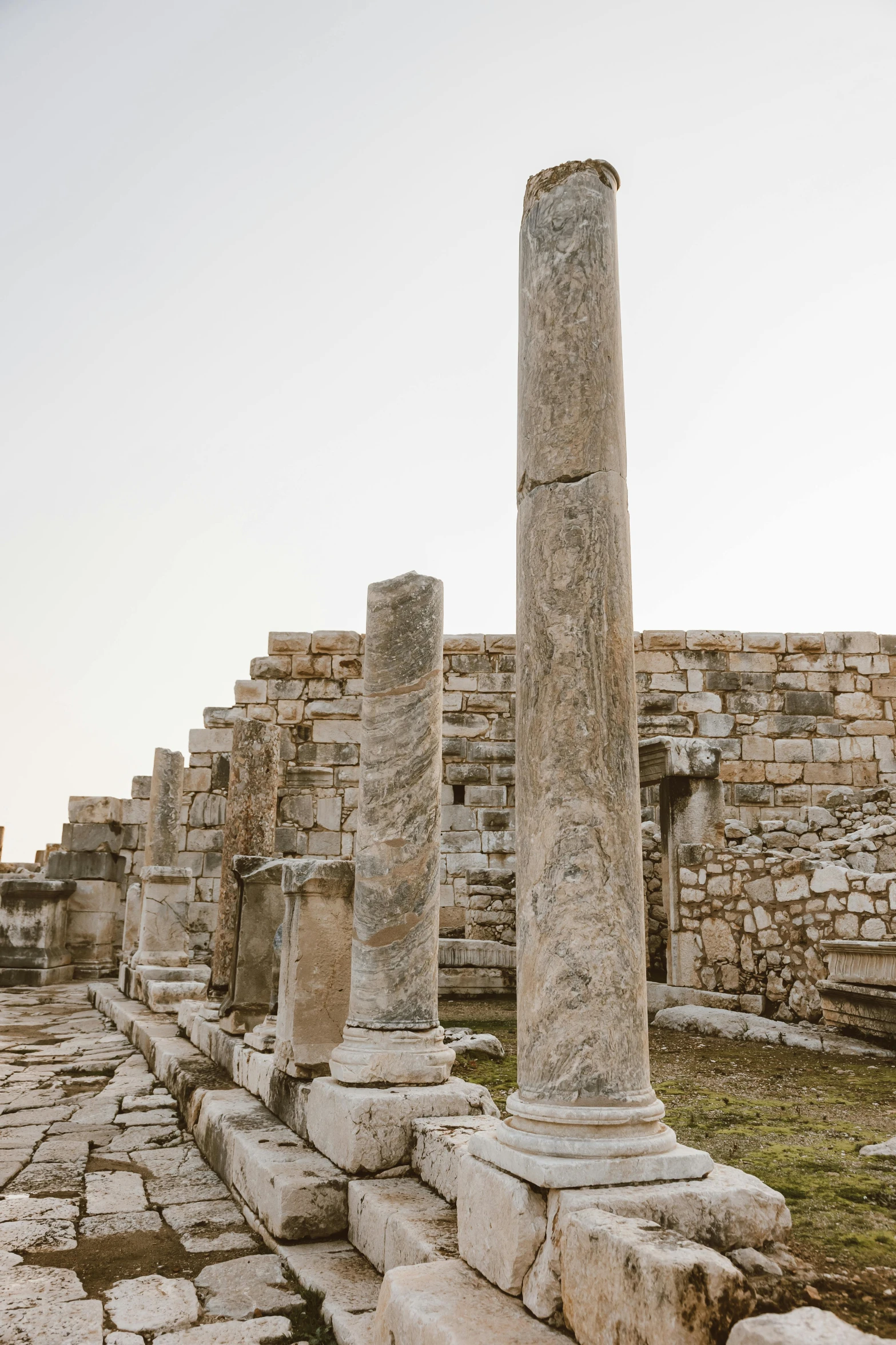 some columns that are in a courtyard by some stone blocks