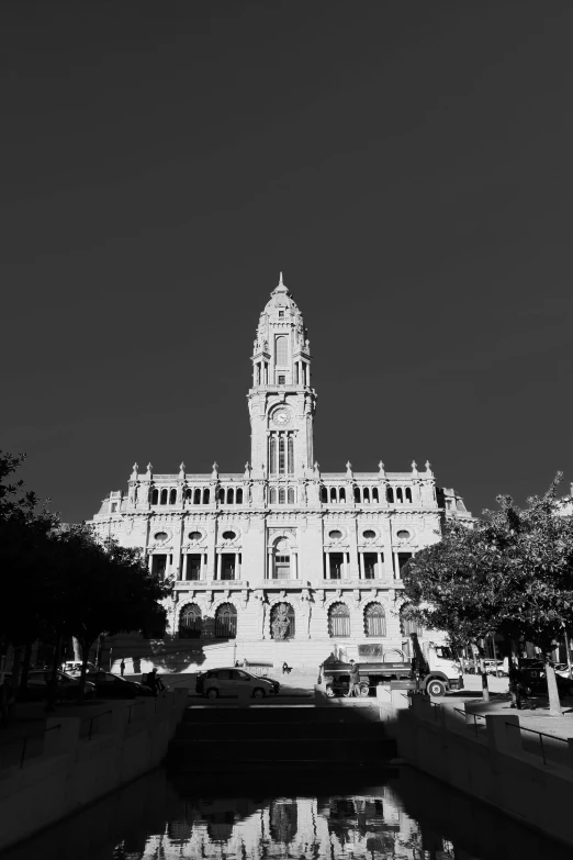 black and white image of a building with trees on the corner