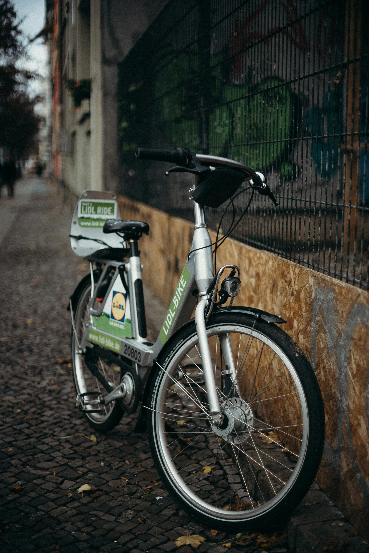 the bike is parked next to a wall