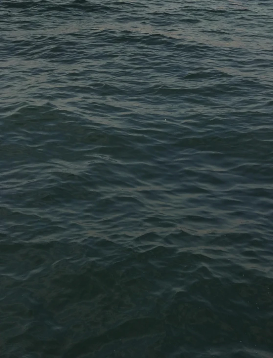 an empty boat out on the ocean in the early morning