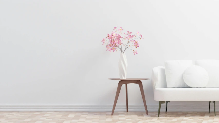 flowers are sitting on an end table next to a couch