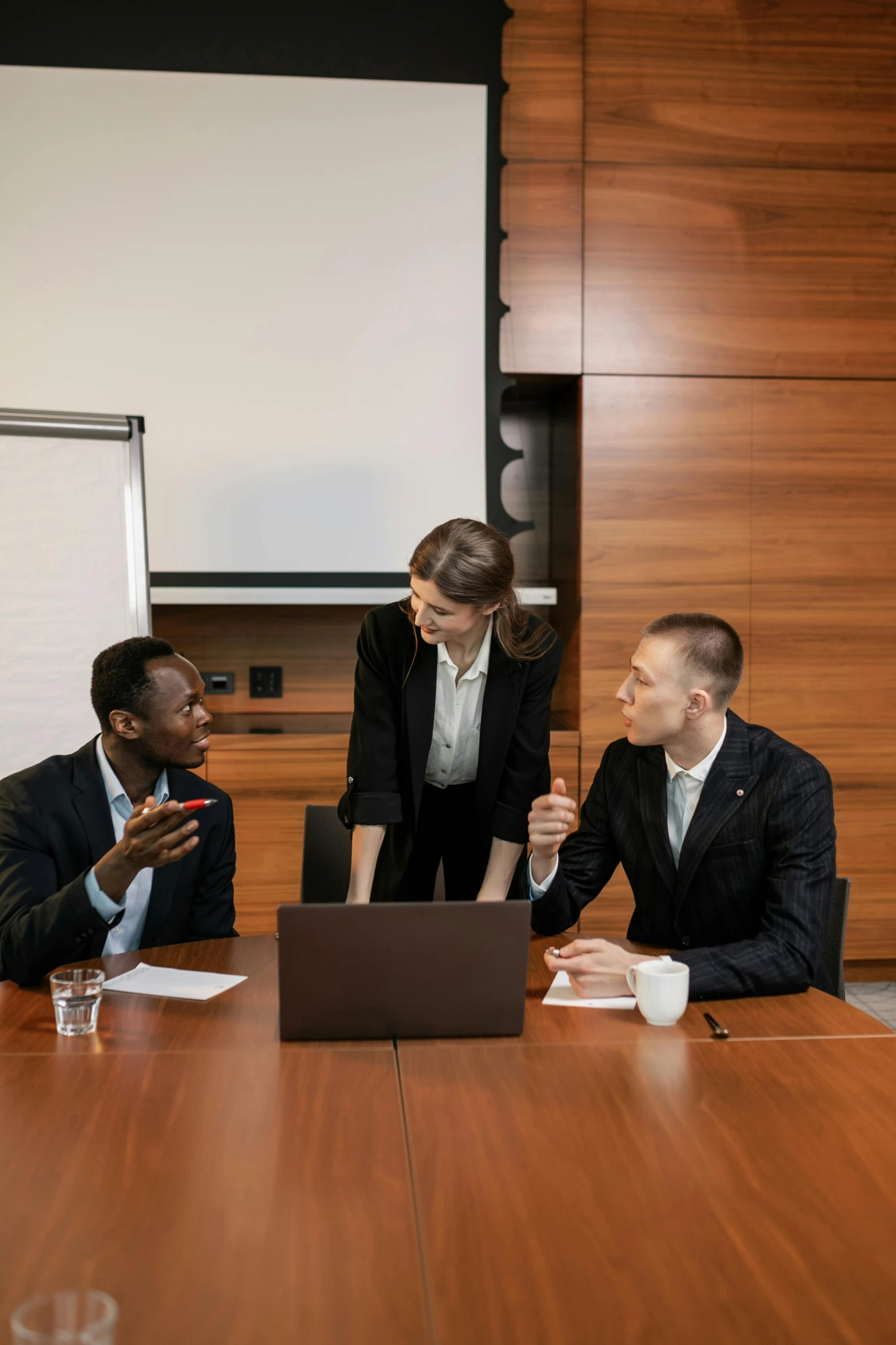 business people having a meeting at a wooden desk