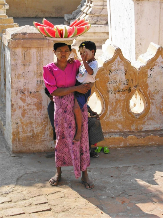 a woman with a baby wearing a colorful hat