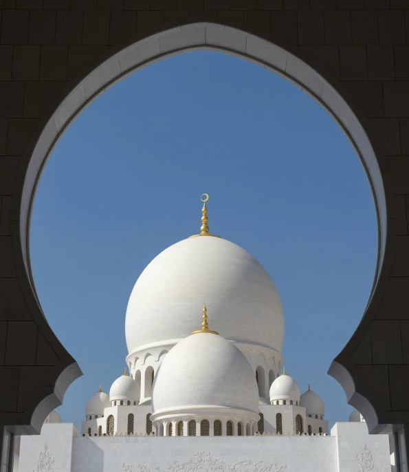 the exterior of an islamic shrine against a clear sky