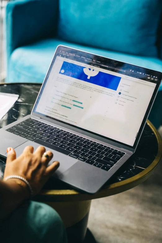 a woman is using her laptop on the table