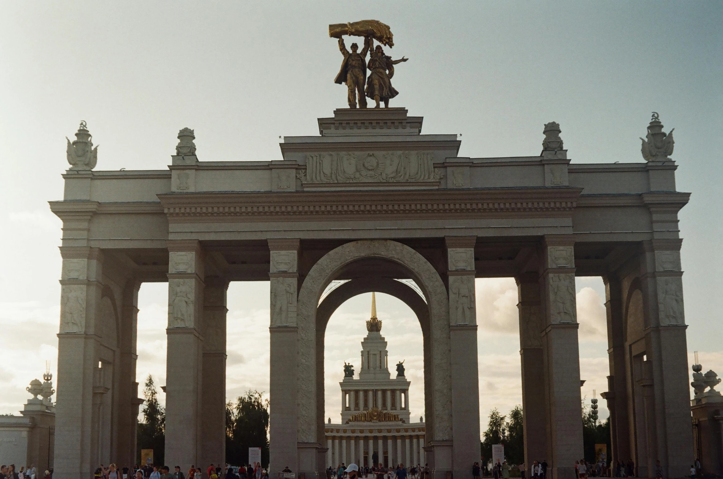 people stand in front of an old gate