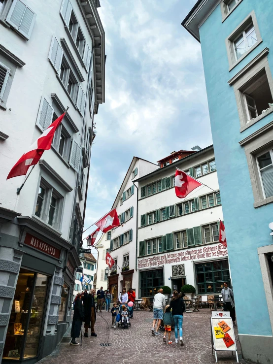 tourists walking on the cobblestone streets of some buildings