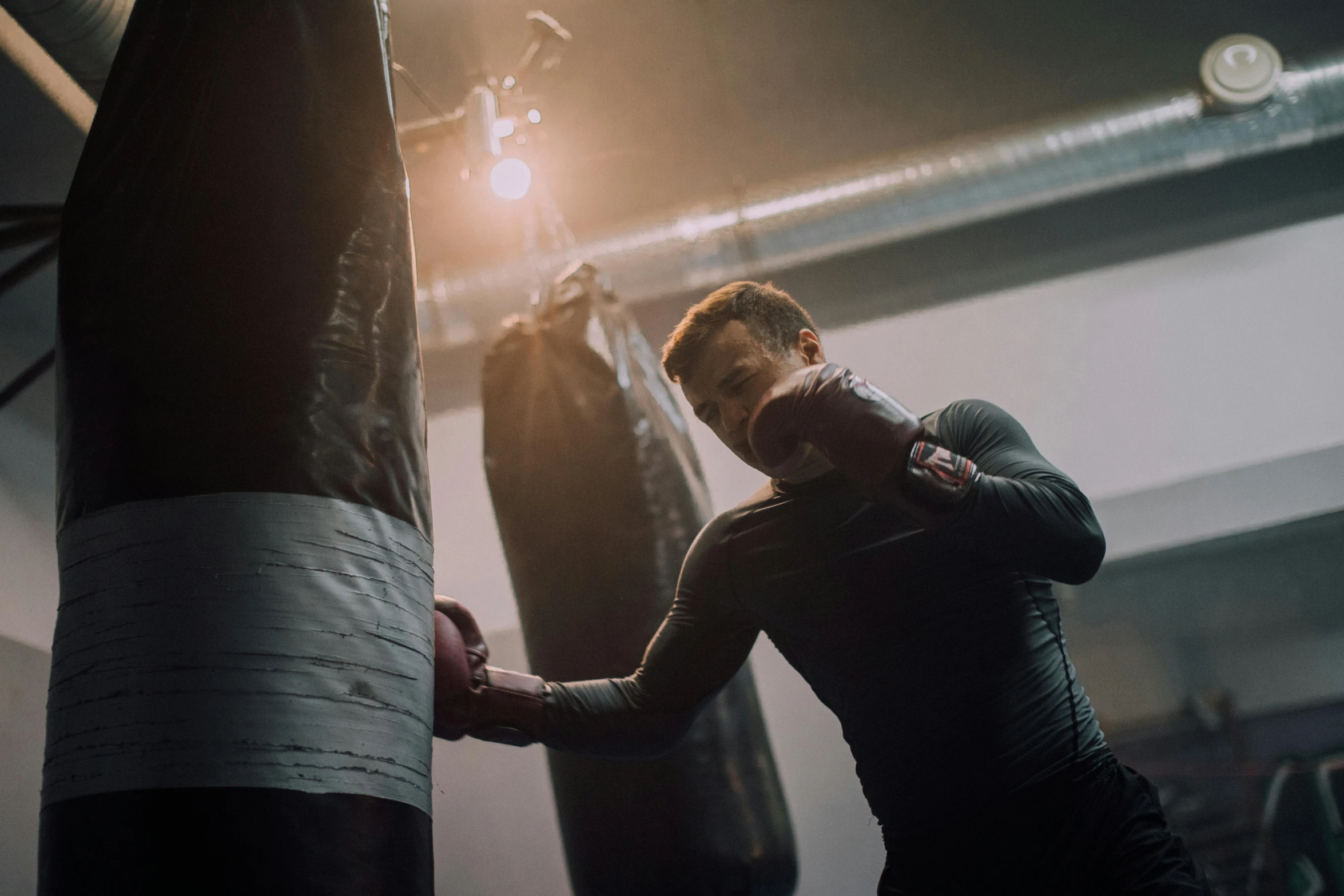 a man punching another person with a punching bag