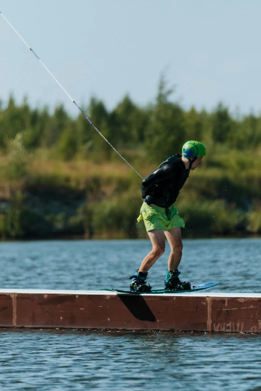 a man is on a board as he rides on water