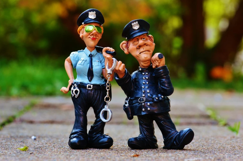 two police men figurines have hands to each other