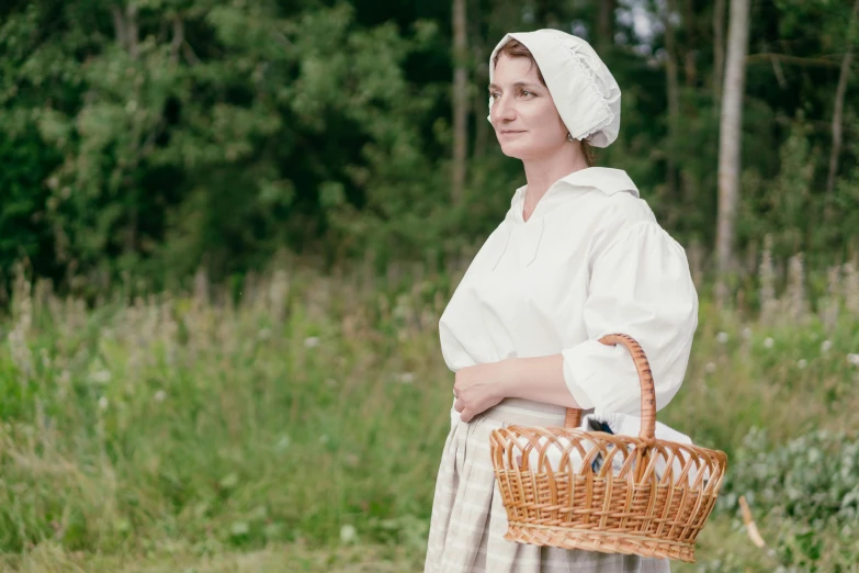 a woman dressed in an old fashion outfit with a basket