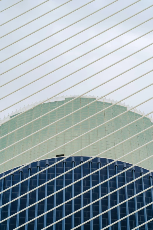 a airplane flies past an office building that's glass panels